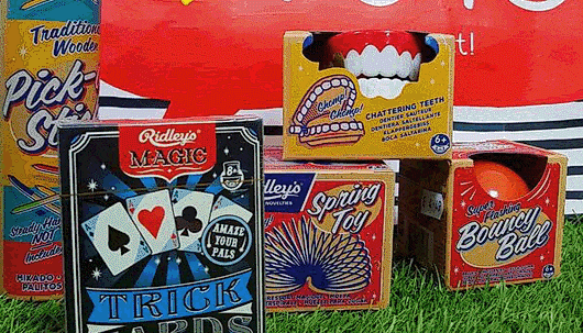 A selection of vintage toys, including playing cards and a bouncy ball