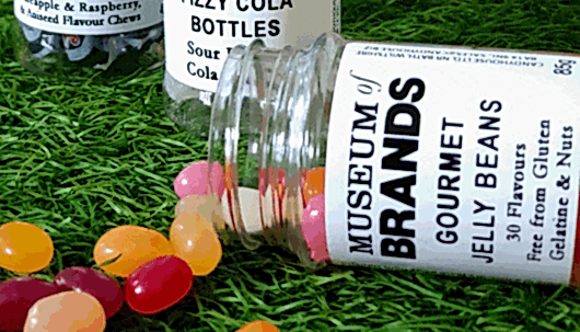 Colourful jelly bean sweets spilling out of a jar that reads Museum of Brands Gourmet Jelly Beans