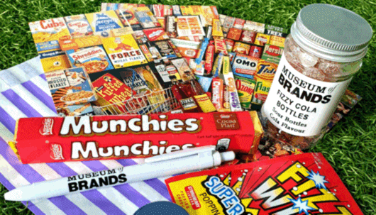 A selection of vintage sweets and postcards on a green background